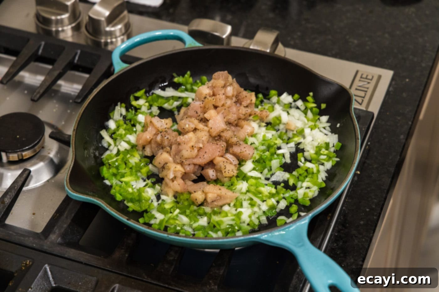 Chimichanga Perfection 9 Adding cubed chicken breast to the skillet with sautéed vegetables for chimichanga filling