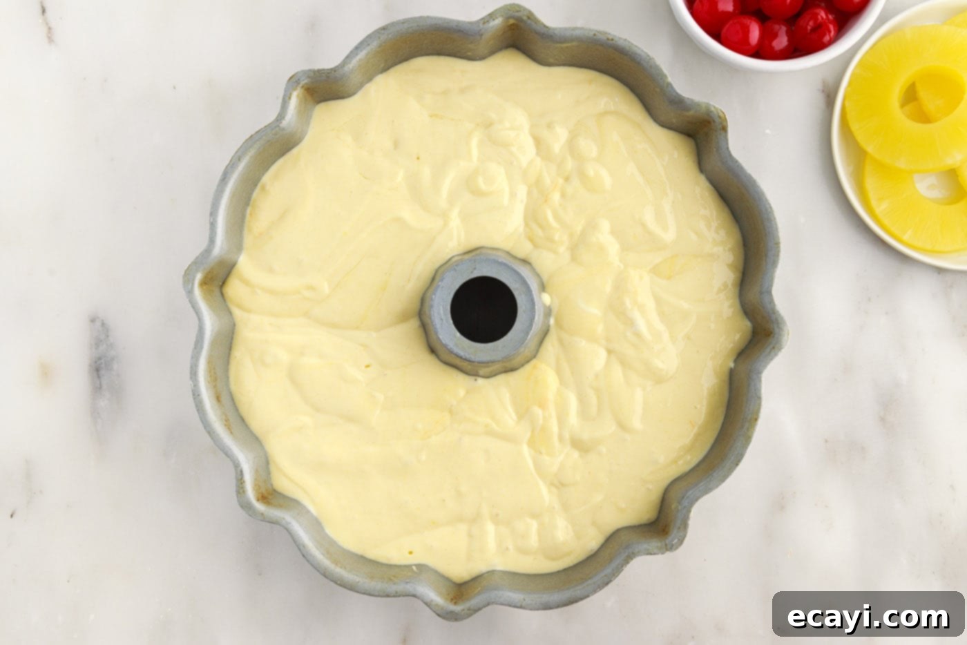 Golden Pineapple Crown Bundt Cake 12 pineapple bundt cake batter in a pan