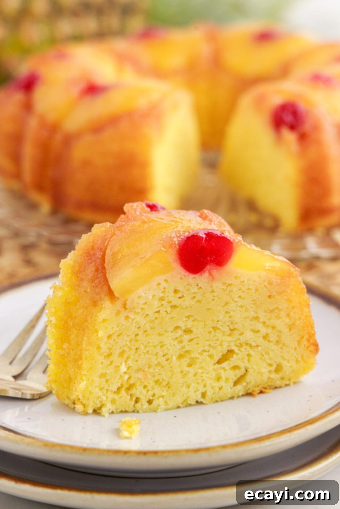 Golden Pineapple Crown Bundt Cake 16 Slice of Pineapple Upside Down Bundt Cake on a plate