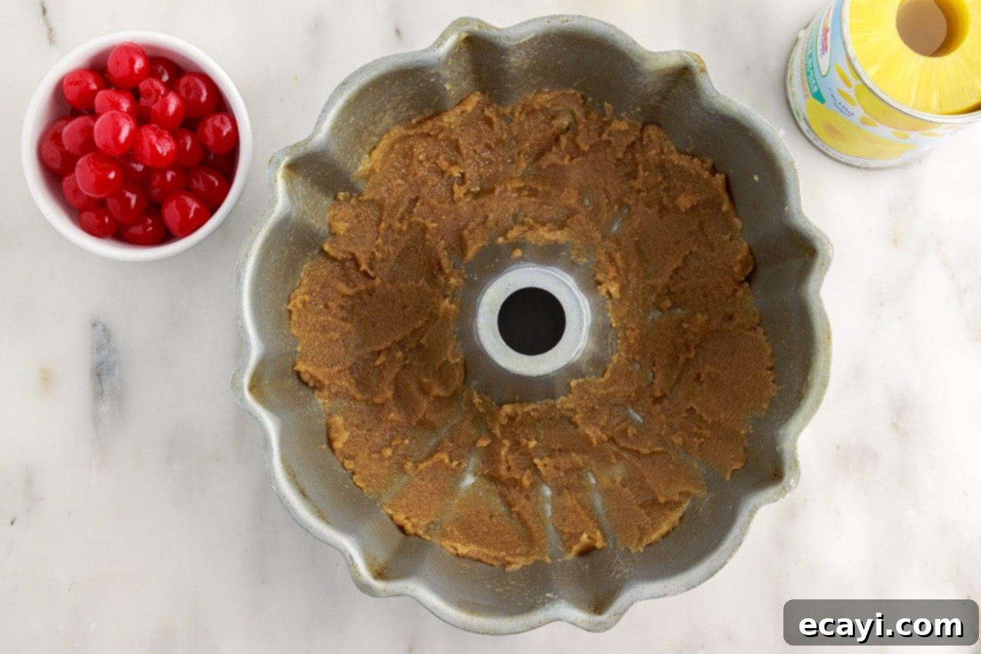 Golden Pineapple Crown Bundt Cake 7 brown sugar mixture spread out in bundt pan