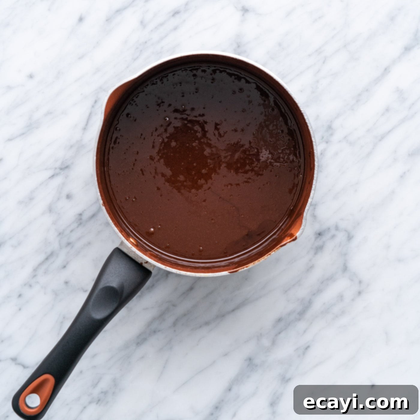 Decadent Chocolate Drizzle 11 homemade hot fudge in a saucepan