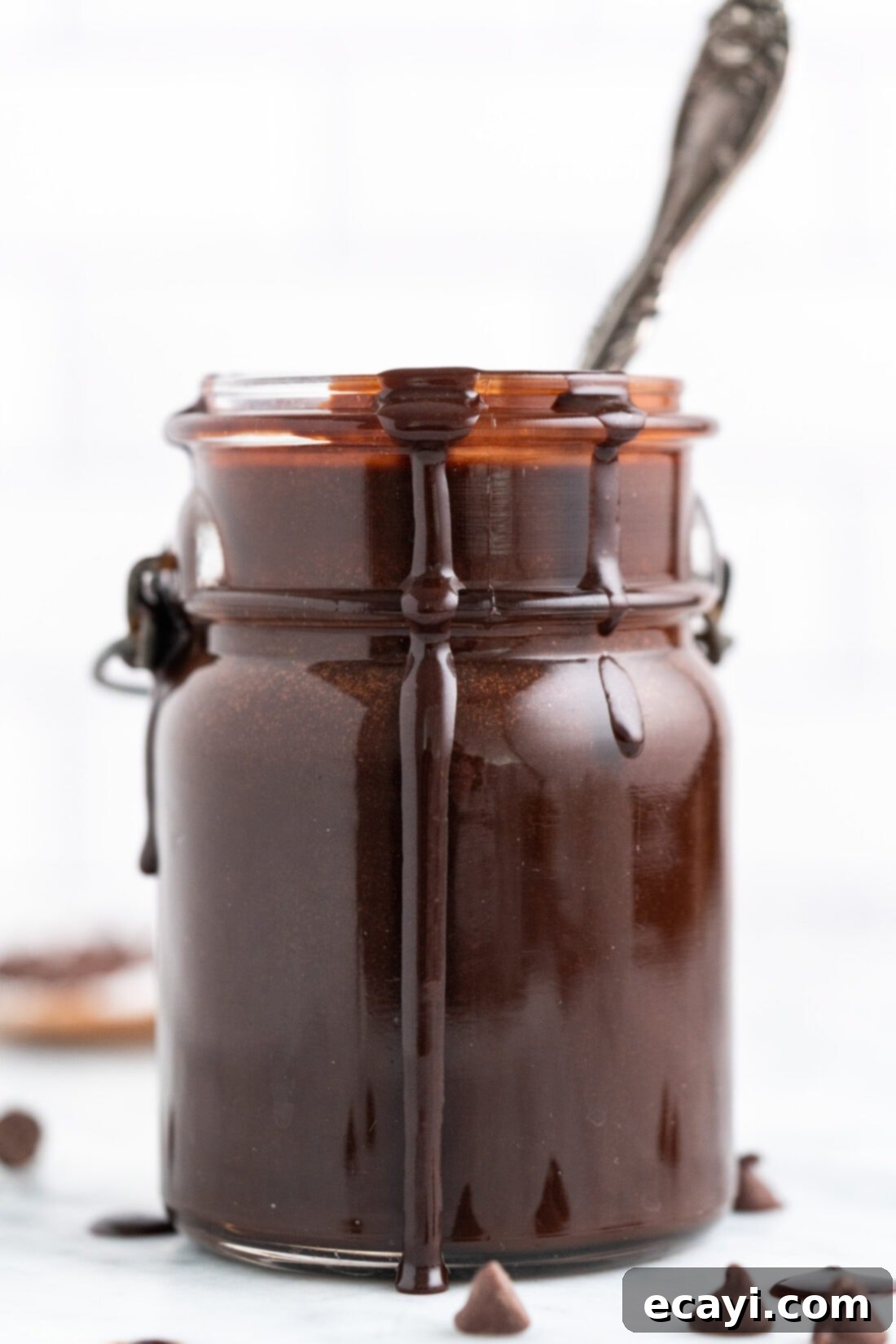 Decadent Chocolate Drizzle 3 Hot Fudge in a jar with a spoon