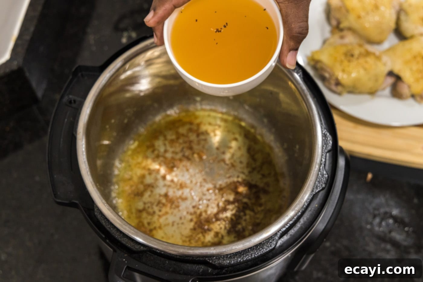 Effortless Instant Pot Chicken Thighs 9 adding chicken stock to bottom of instant pot