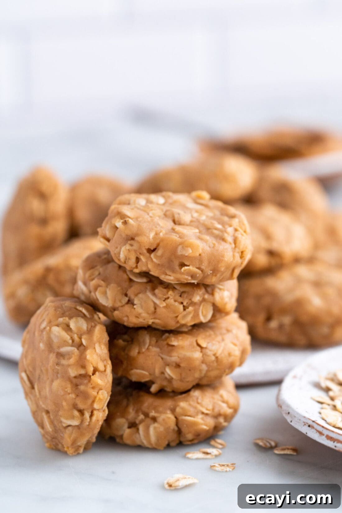 Peanut Butter Bliss Bites 3 A stack of perfectly formed No Bake Peanut Butter Cookies, showing their chewy oat texture