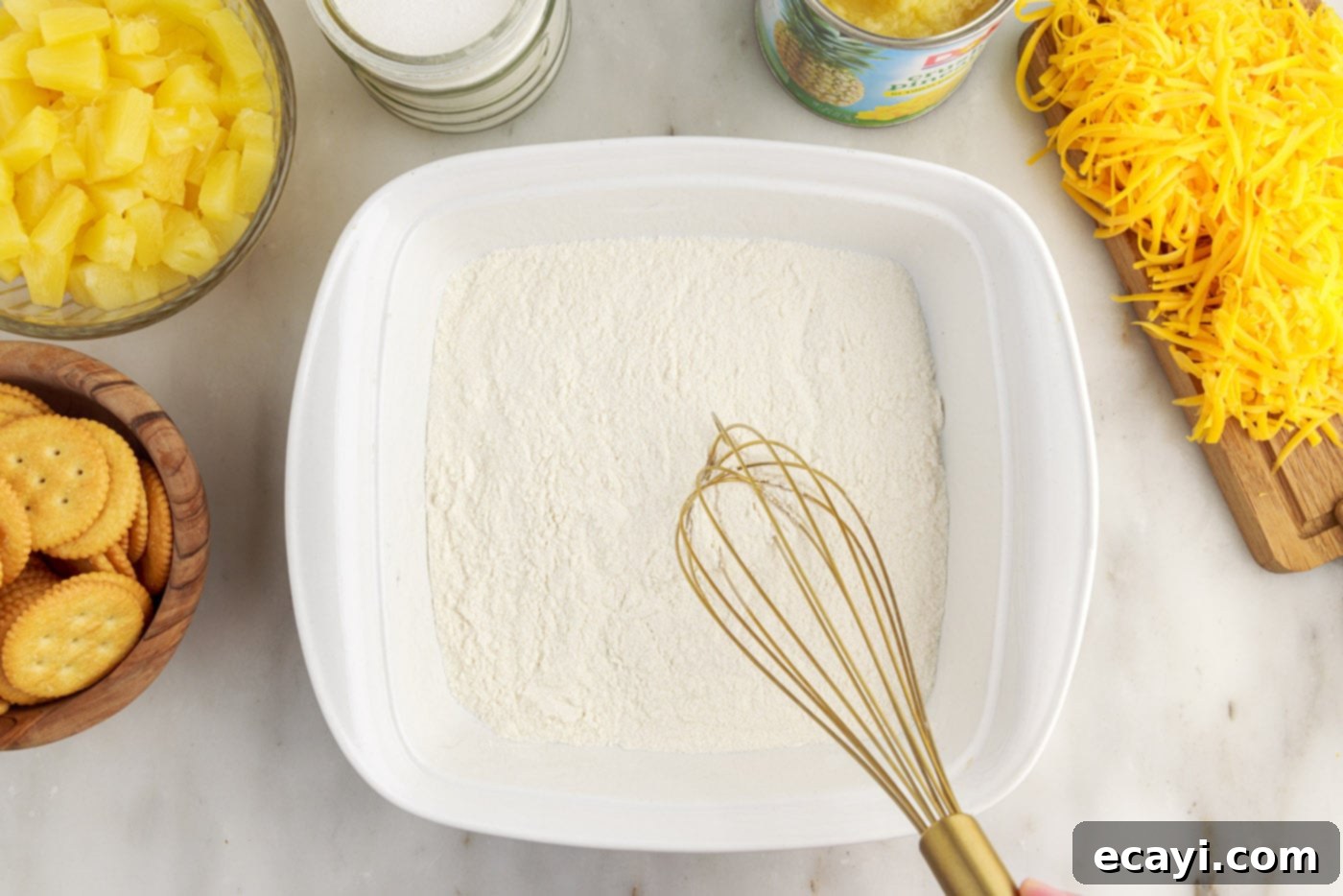 Sweet Pineapple Bake 5 whisking flour and sugar in a baking dish