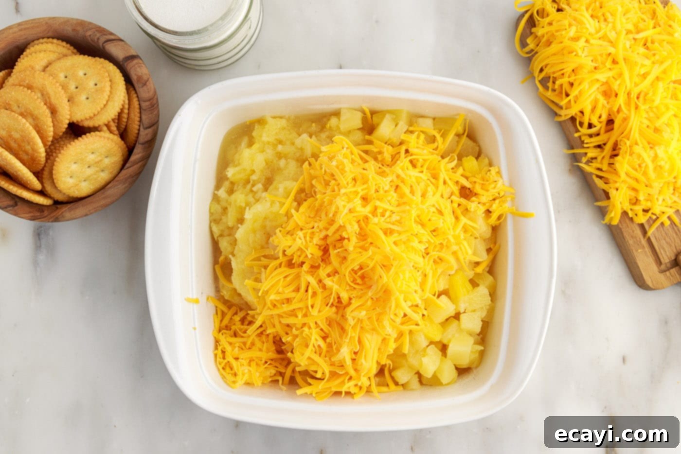 Sweet Pineapple Bake 6 grated cheddar cheese and pineapple added to baking dish