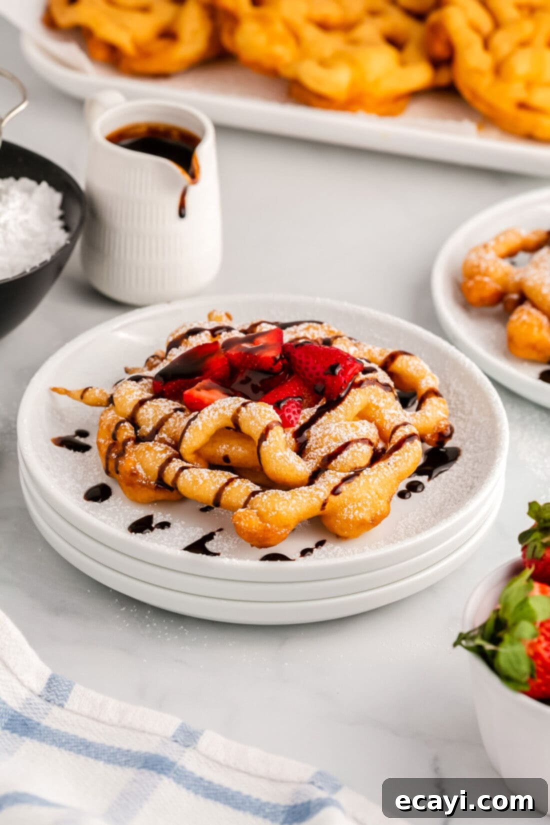 Carnival Classic: The Art of Funnel Cake 14 Funnel Cake topped with powdered sugar, chocolate sauce and strawberries