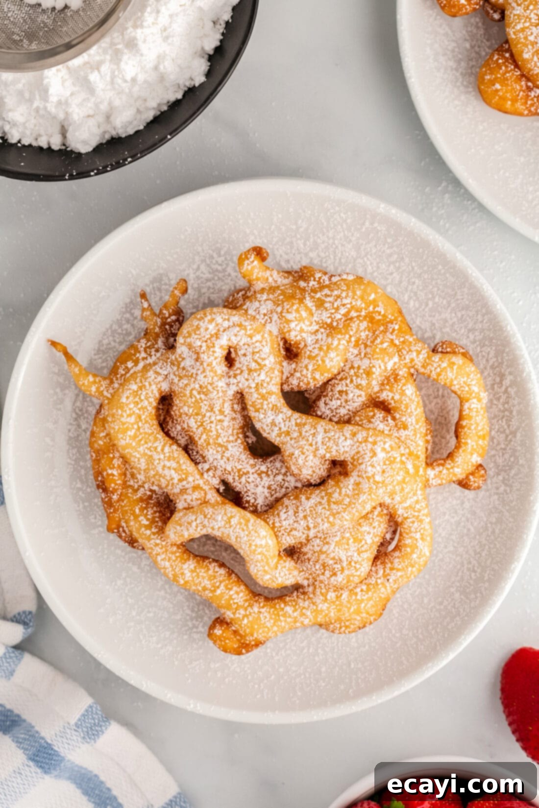 Carnival Classic: The Art of Funnel Cake 3 Overhead photo of a Funnel Cake topped with powdered sugar