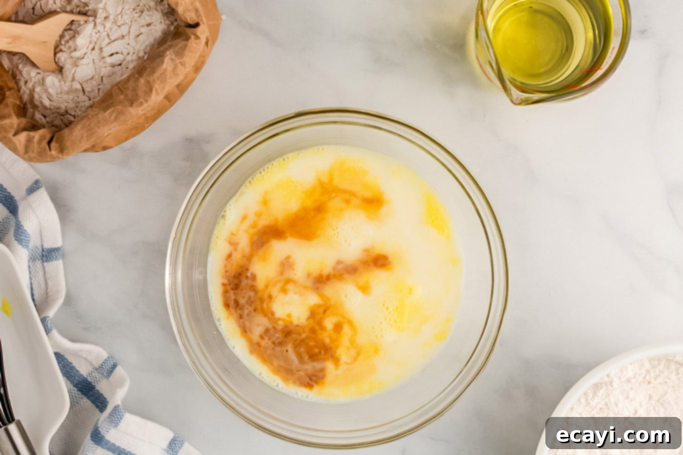 Carnival Classic: The Art of Funnel Cake 7 egg, milk, water, and vanilla mixed in a bowl