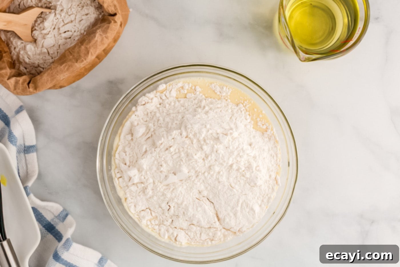 Carnival Classic: The Art of Funnel Cake 9 adding dry ingredients to wet ingredients