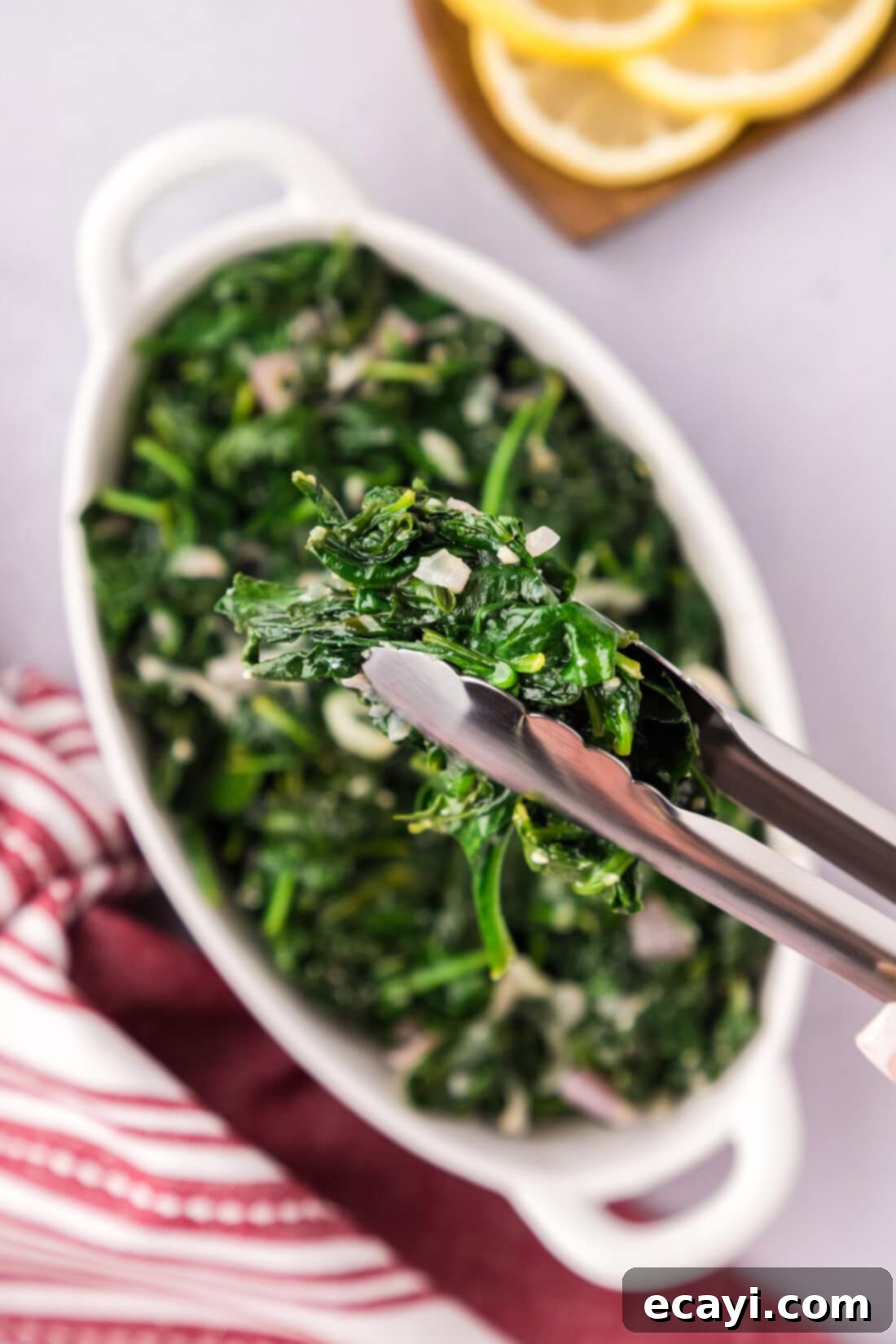Garlic Spinach Sauté 2 Sautéed Spinach in a pair of tongs