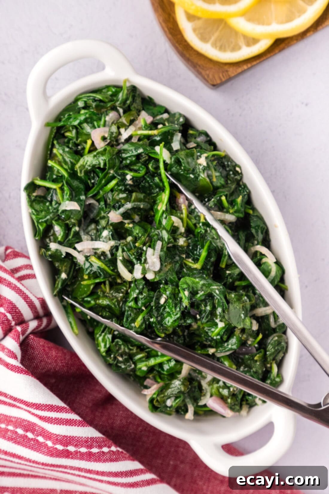 Garlic Spinach Sauté 9 Sautéed Spinach in a serving platter with serving tongs