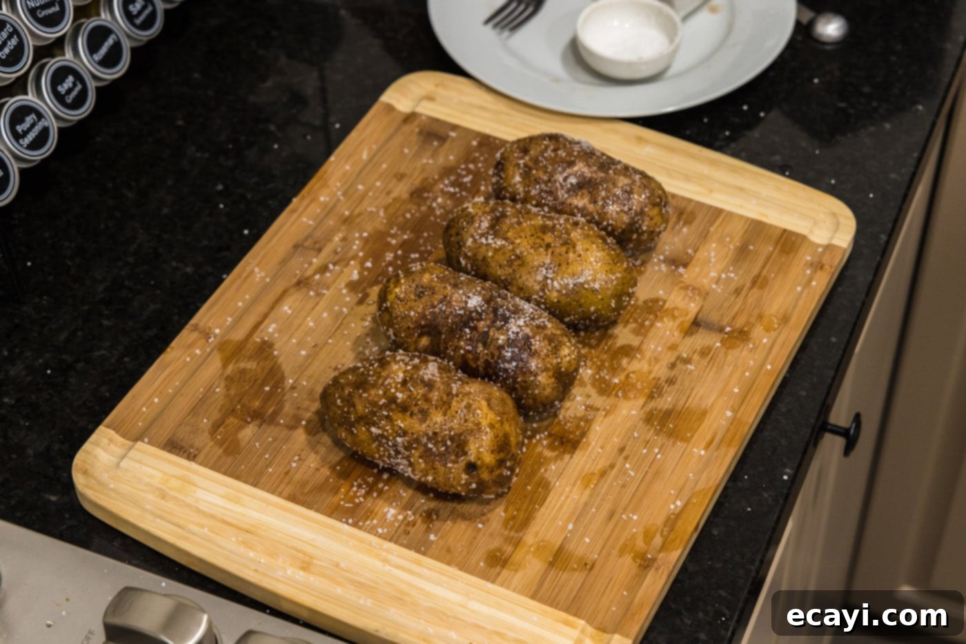 Baked Potato Perfection 6 seasoned potatoes on a cutting board