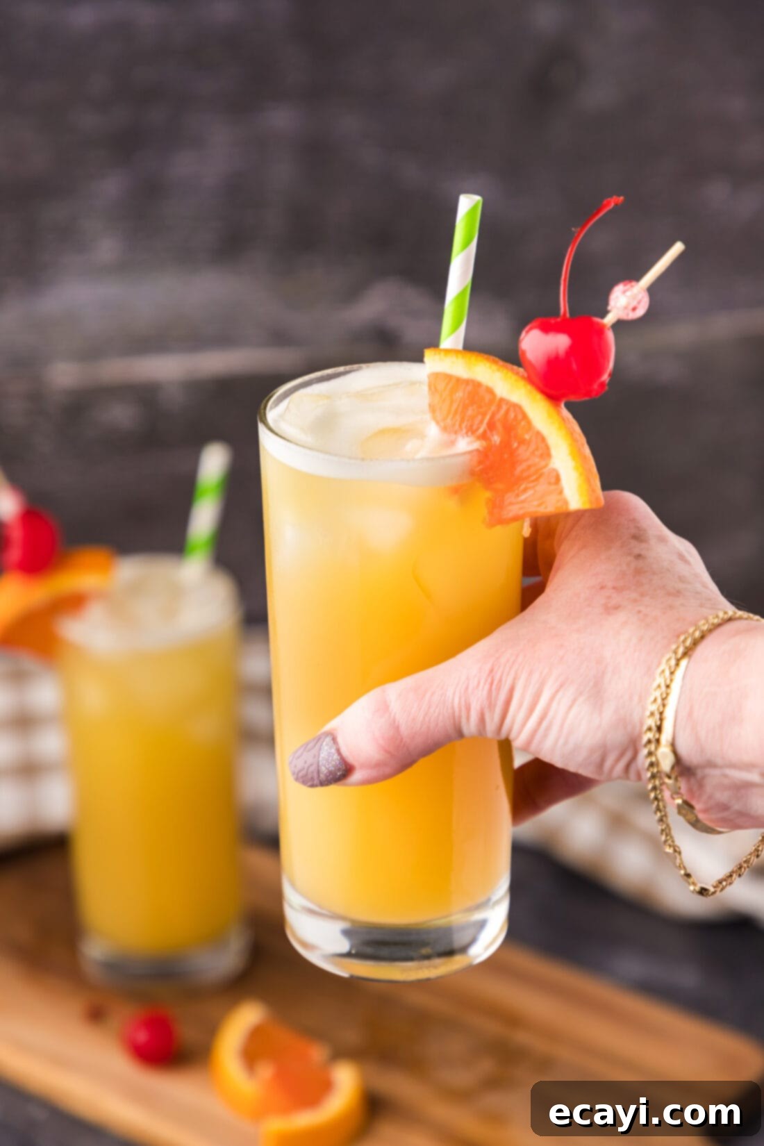 The Unhinged Sip 2 Hand holding up a Skrew Loose Cocktail