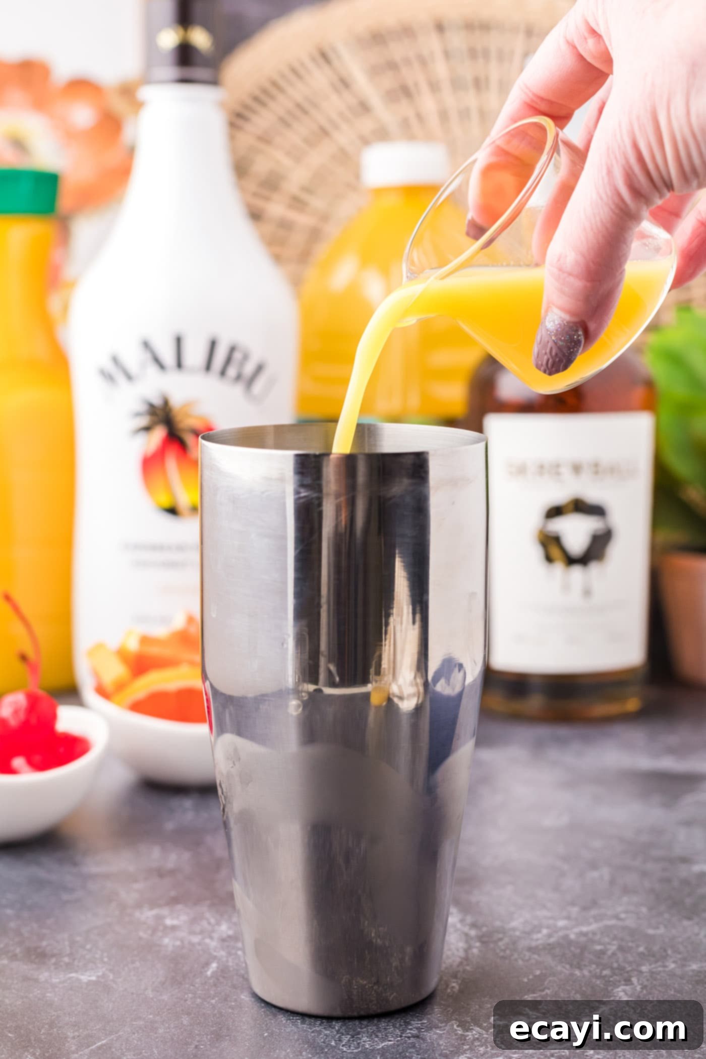 The Unhinged Sip 8 pouring juice into cocktail shaker with rum and whiskey