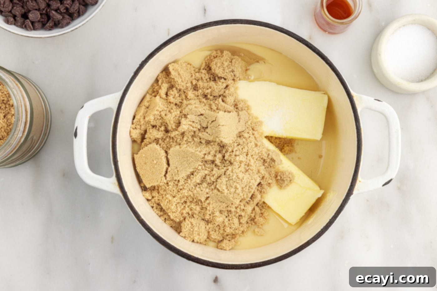 Golden Caramel Indulgence 11 All caramel ingredients: butter, brown sugar, sweetened condensed milk, corn syrup, vanilla, and salt placed in a saucepan before heating.