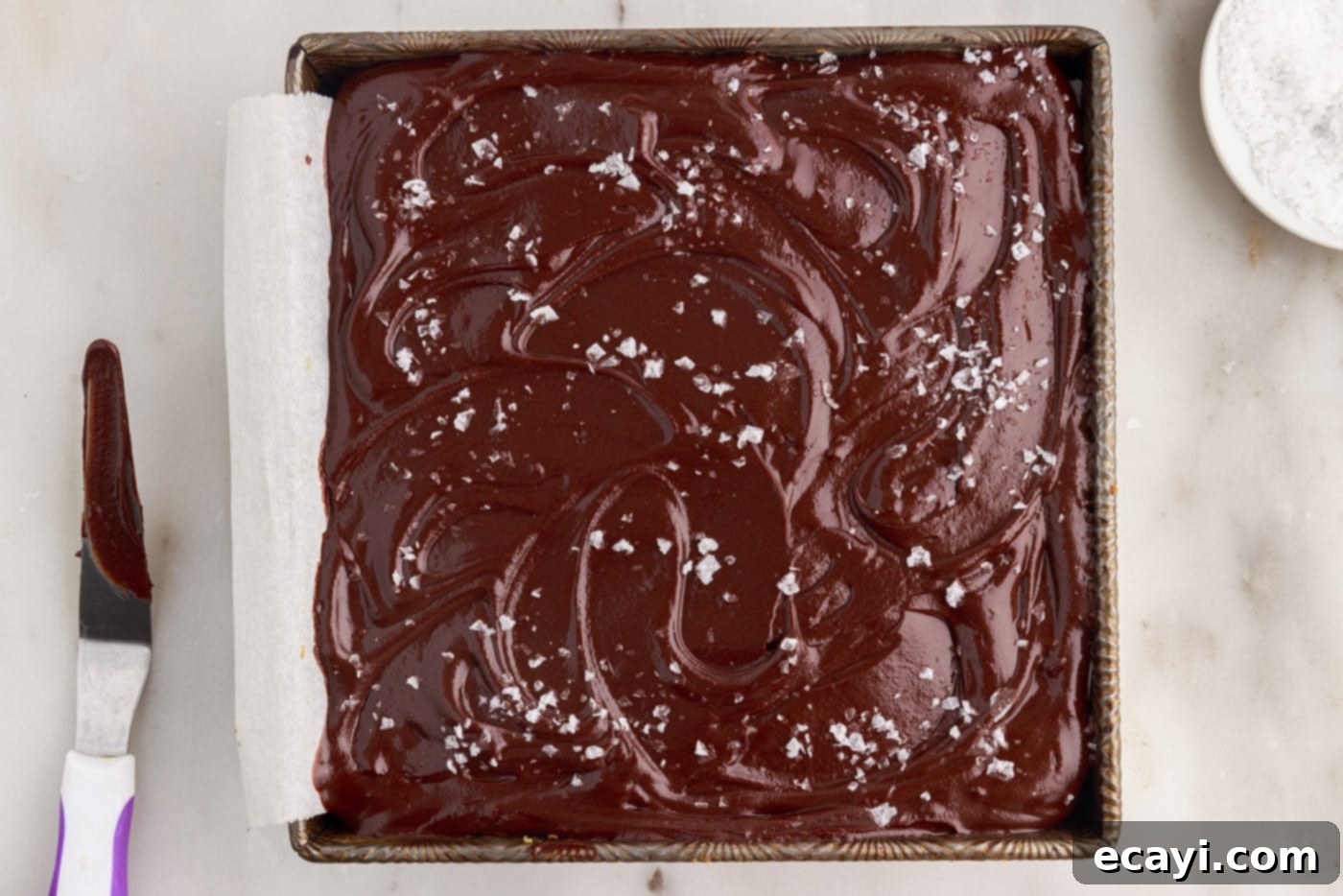 Golden Caramel Indulgence 17 Millionaire’s Bars chilling with a sprinkle of flaky sea salt on top of the chocolate ganache layer.
