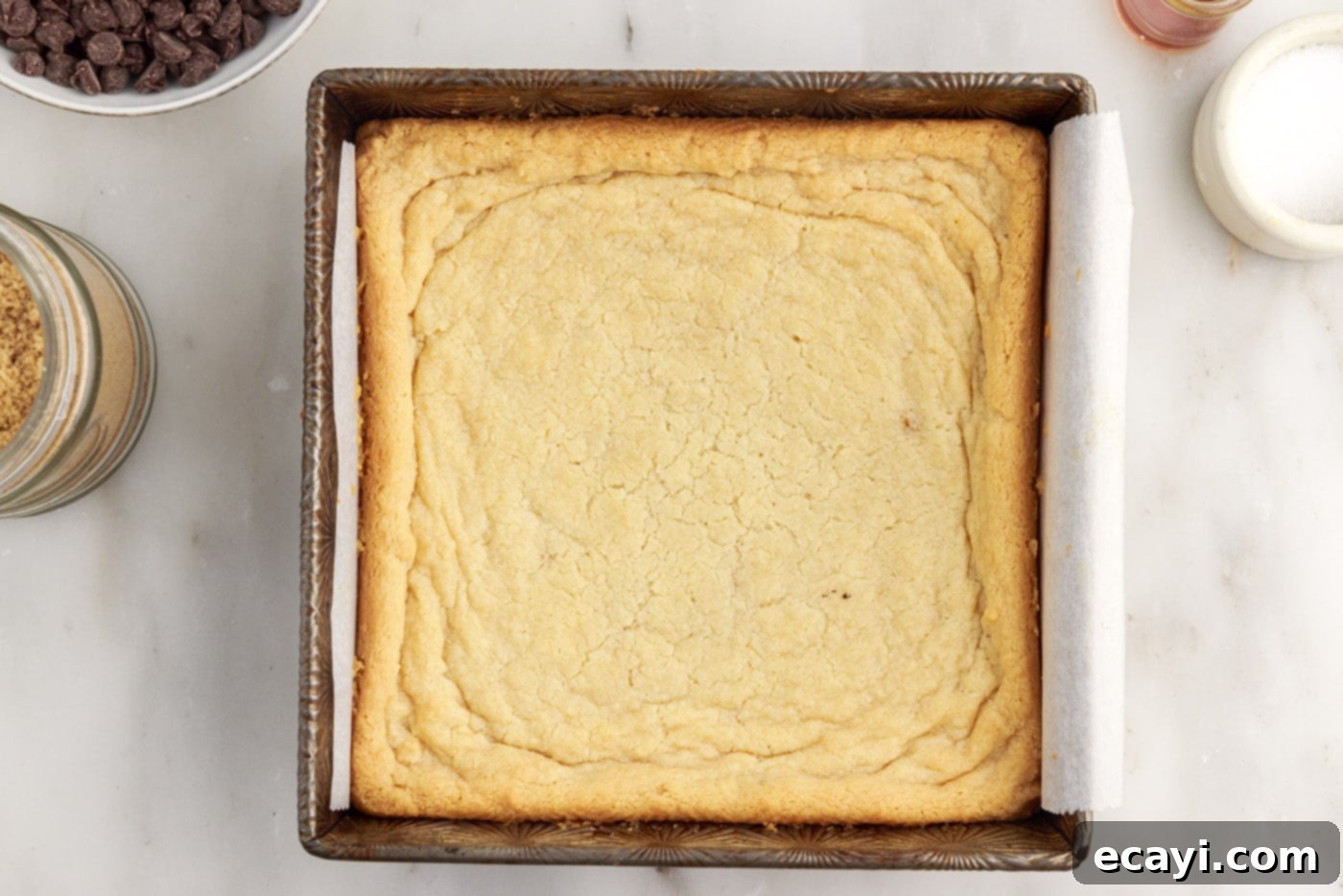 Golden Caramel Indulgence 10 Freshly baked golden brown shortbread crust cooling in a baking pan.