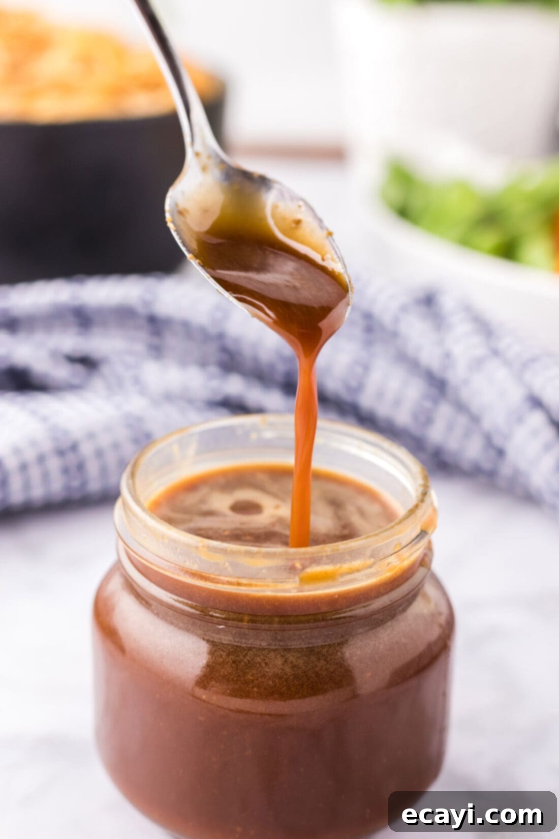 Whip Up Your Own Teriyaki Sauce 2 Homemade Teriyaki Sauce drizzled from a spoon into a jar