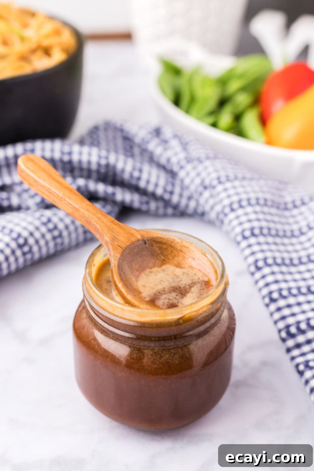 Whip Up Your Own Teriyaki Sauce 3 Wooden spoon resting in a jar of Homemade Teriyaki Sauce