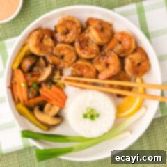 Sizzling Hibachi Shrimp 12 A beautifully presented bowl of Hibachi Shrimp with vegetables and rice, ready to be served.
