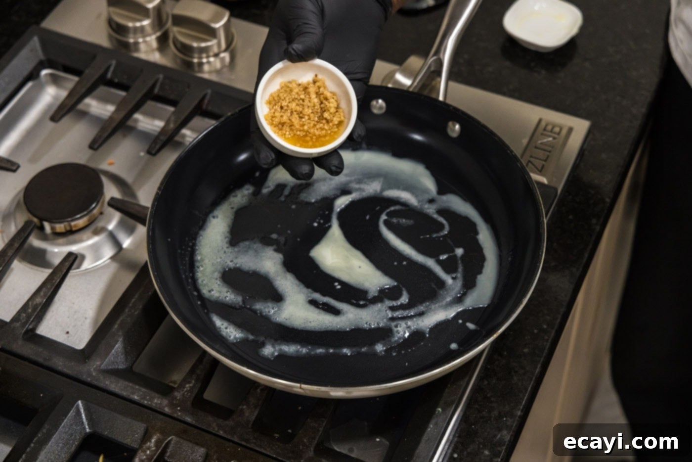 Sizzling Hibachi Shrimp 5 Minced garlic being added to a skillet with melted butter, creating an aromatic base for the shrimp.