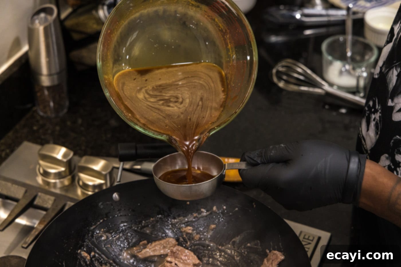 Savory Teriyaki Beef 7 pouring teriyaki sauce into a measuring cup