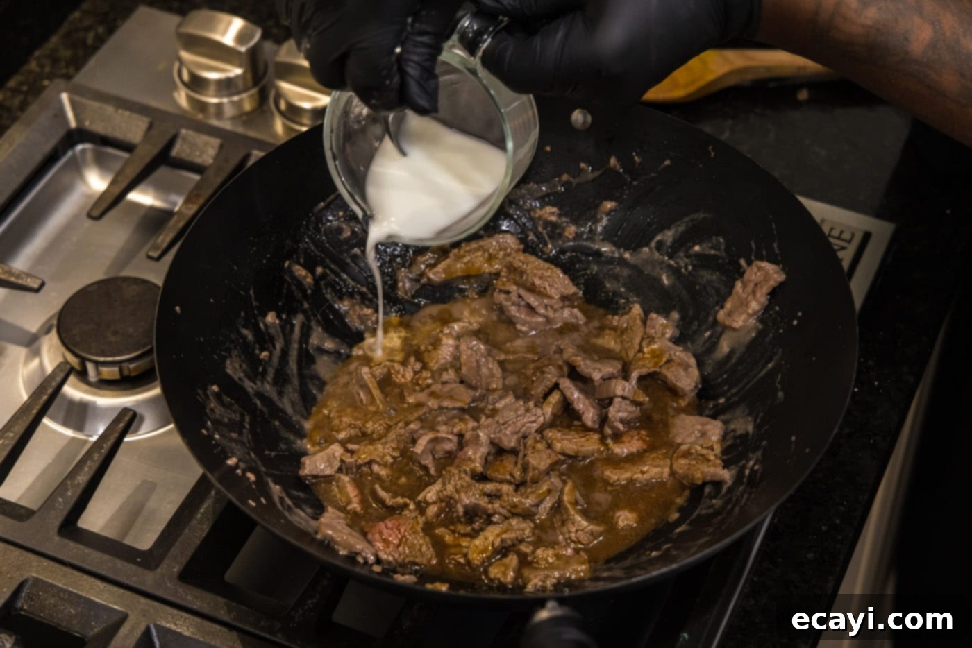 Savory Teriyaki Beef 8 adding cornstarch water to skillet with beef strips and teriyaki sauce