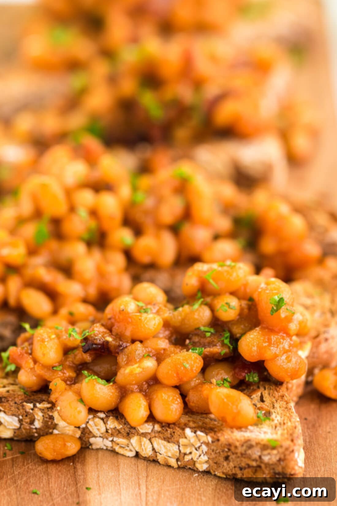 Hearty Beans, Crispy Toast 2 Close up photo of Beans on Toast, a British comfort food staple, served on a plate