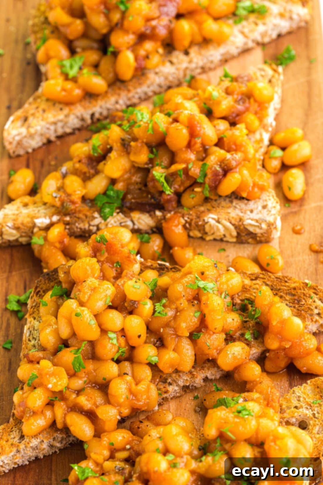 Hearty Beans, Crispy Toast 4 Close up photo of Beans on Toast on a wooden platter, ready to be enjoyed as a hearty dish