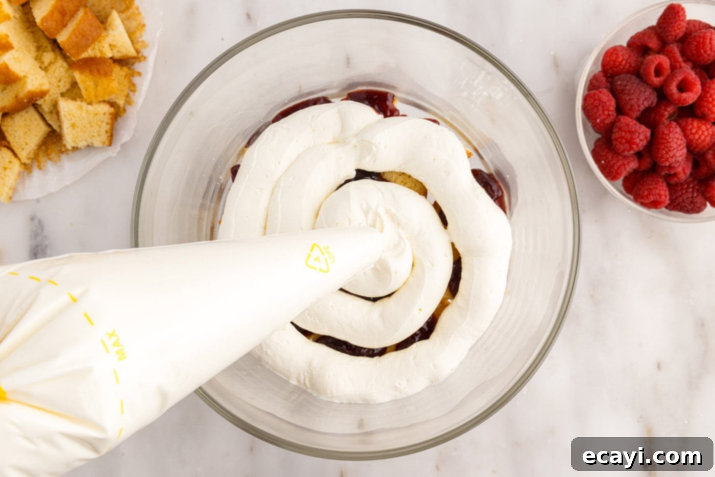 Raspberry Trifle 13 piping the whipped cream cheese mixture over the pound cake and jam layers
