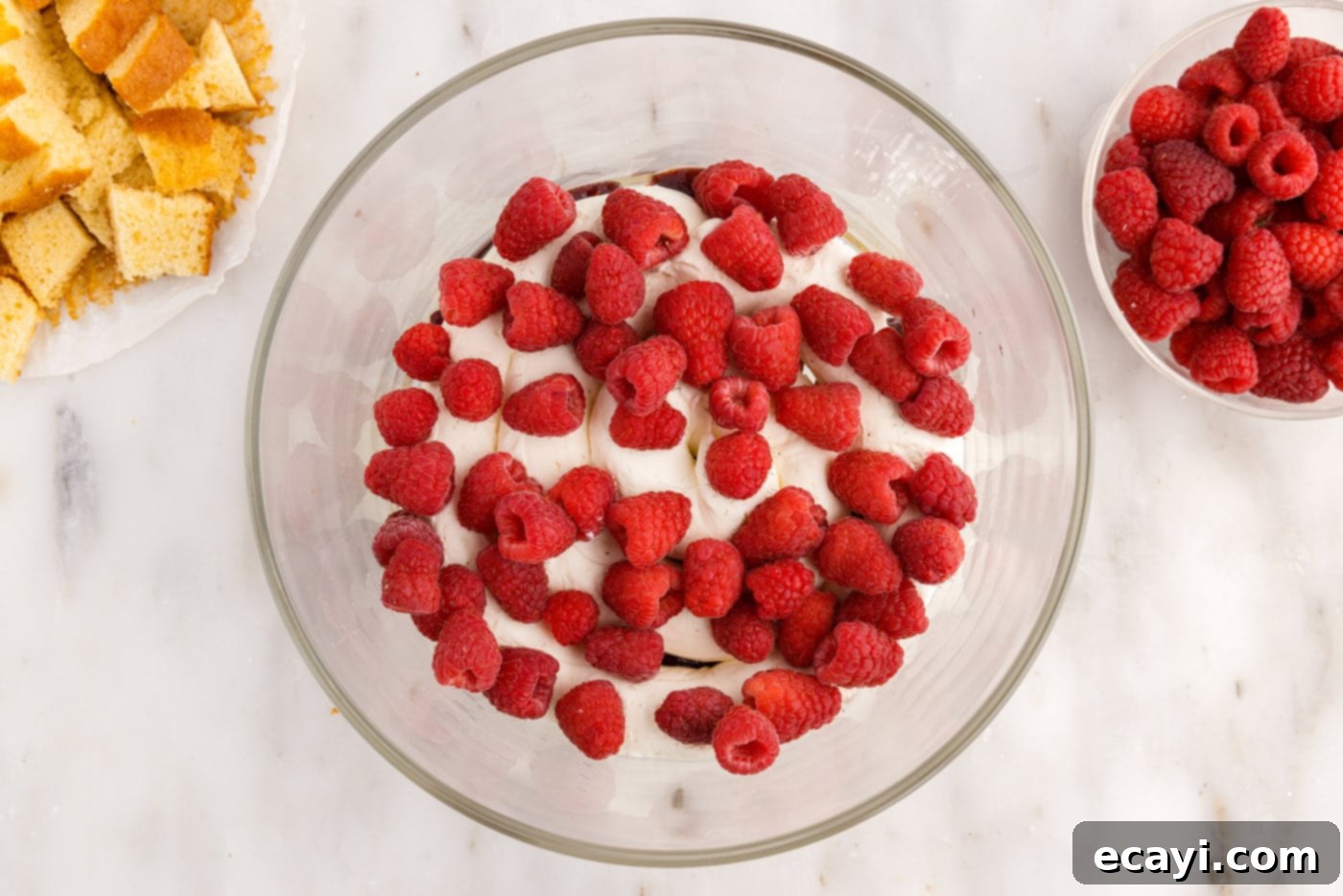Raspberry Trifle 14 fresh raspberries sprinkled on top of the cream cheese layer in the trifle
