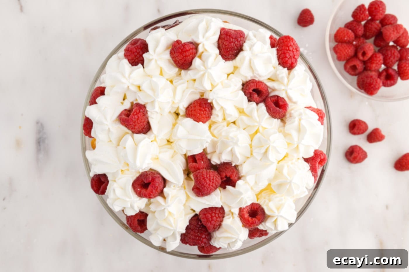 Raspberry Trifle 15 final layer of whipped cream on the raspberry trifle, topped with fresh raspberries