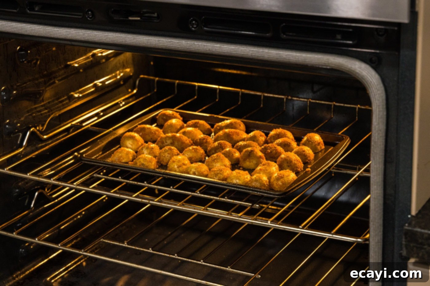 Crispy Parmesan Potatoes 12 Close-up of perfectly baked parmesan potatoes on a baking sheet, golden and crispy