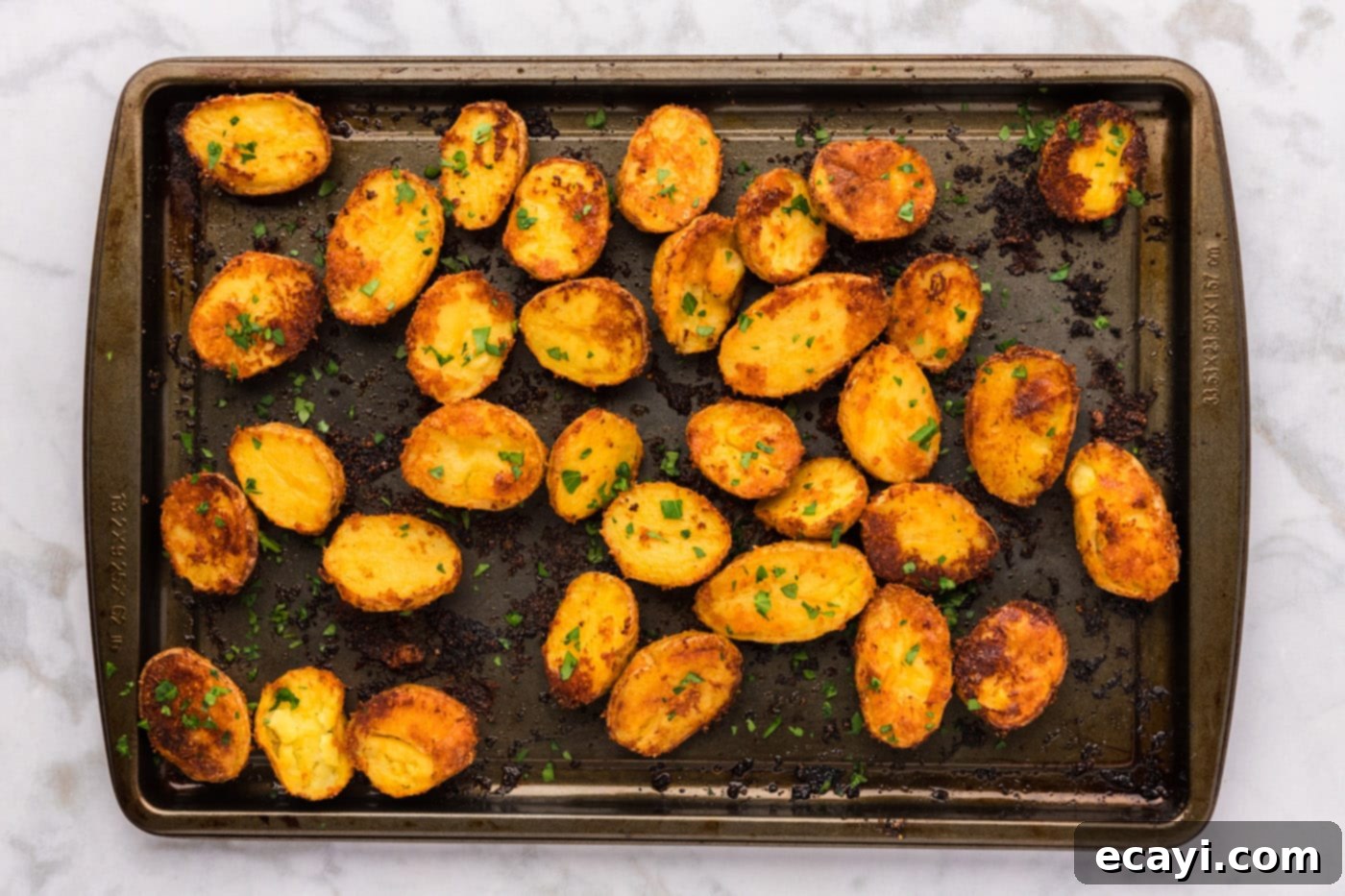 Crispy Parmesan Potatoes 14 Finished roasted parmesan potatoes spread across a baking sheet, perfectly golden and crispy