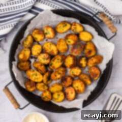 Crispy Parmesan Potatoes 16 Parmesan Potatoes in a metal serving tray, golden and ready to be enjoyed