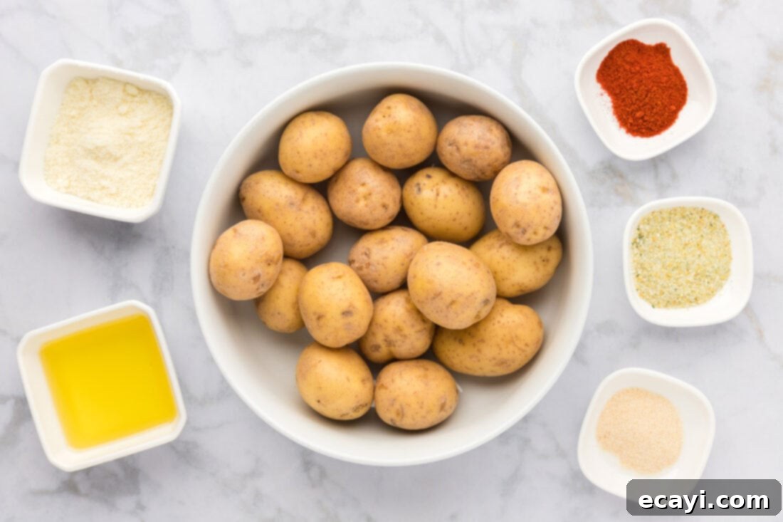Crispy Parmesan Potatoes 4 All ingredients laid out on a counter for making Parmesan Potatoes, including potatoes, cheese, and spices