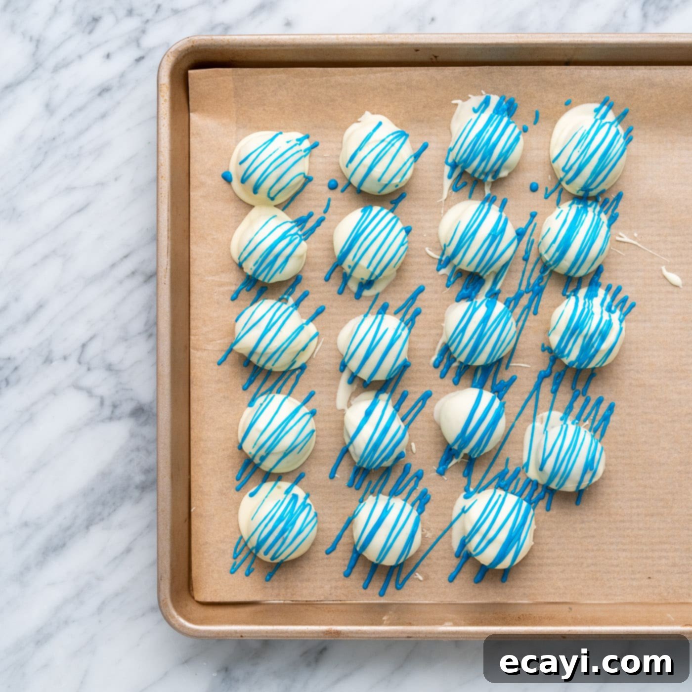 Stars and Stripes Oreo Truffles 15 Blue drizzle being applied over white chocolate oreo truffles
