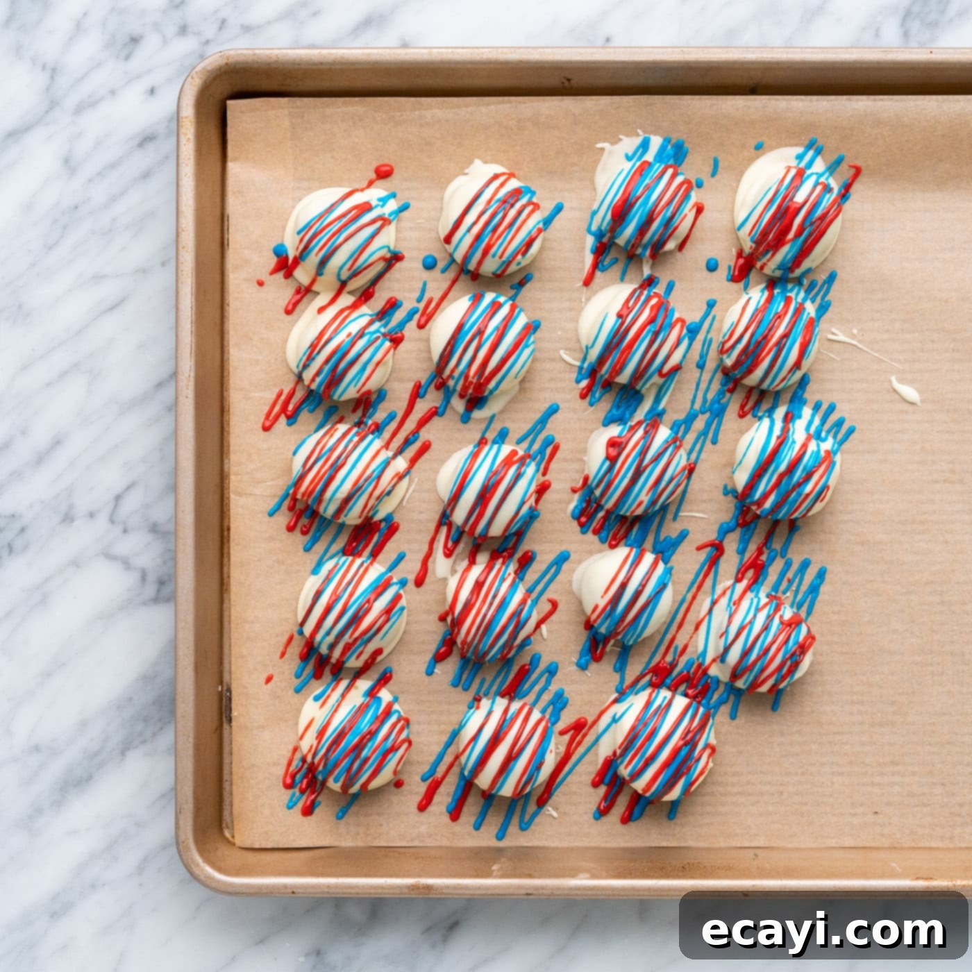 Stars and Stripes Oreo Truffles 16 Red and blue drizzled oreo truffles on a baking sheet, setting