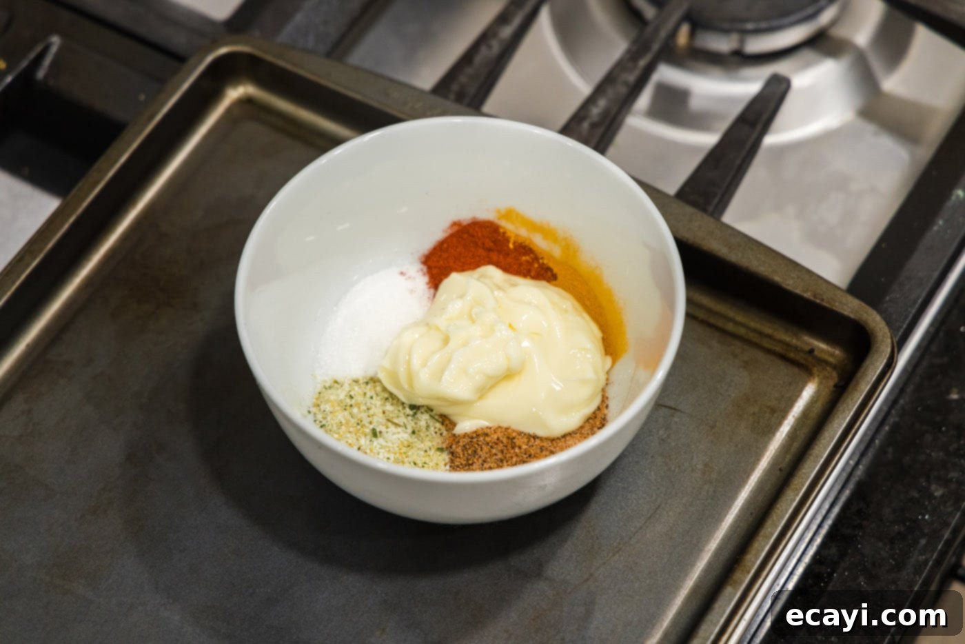 Blistered Spicy Cauliflower 5 butter and cajun spices in a mixing bowl