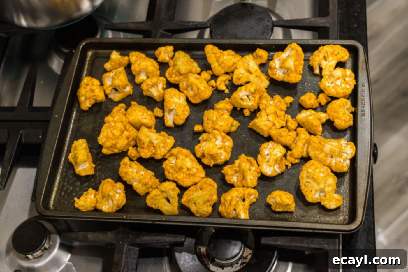 Blistered Spicy Cauliflower 9 spicy cauliflower florets on a baking sheet