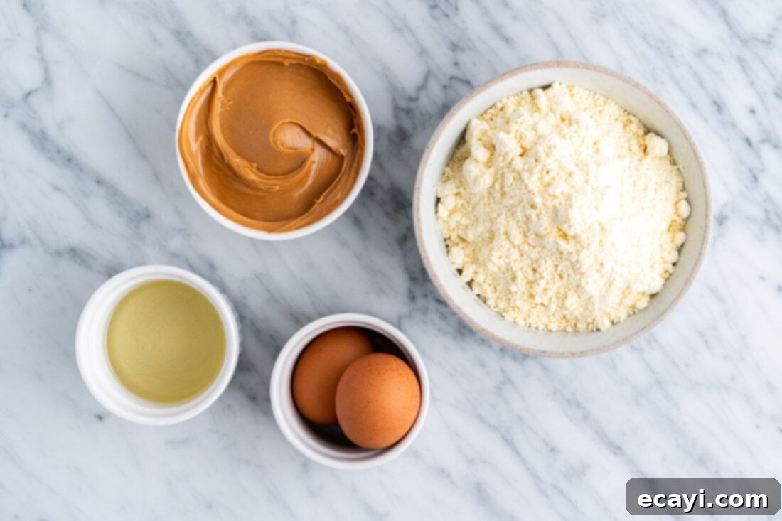 Peanut Butter Cake Mix Delights 4 All four ingredients for Peanut Butter Cake Mix Cookies laid out: cake mix, peanut butter, eggs, and oil.