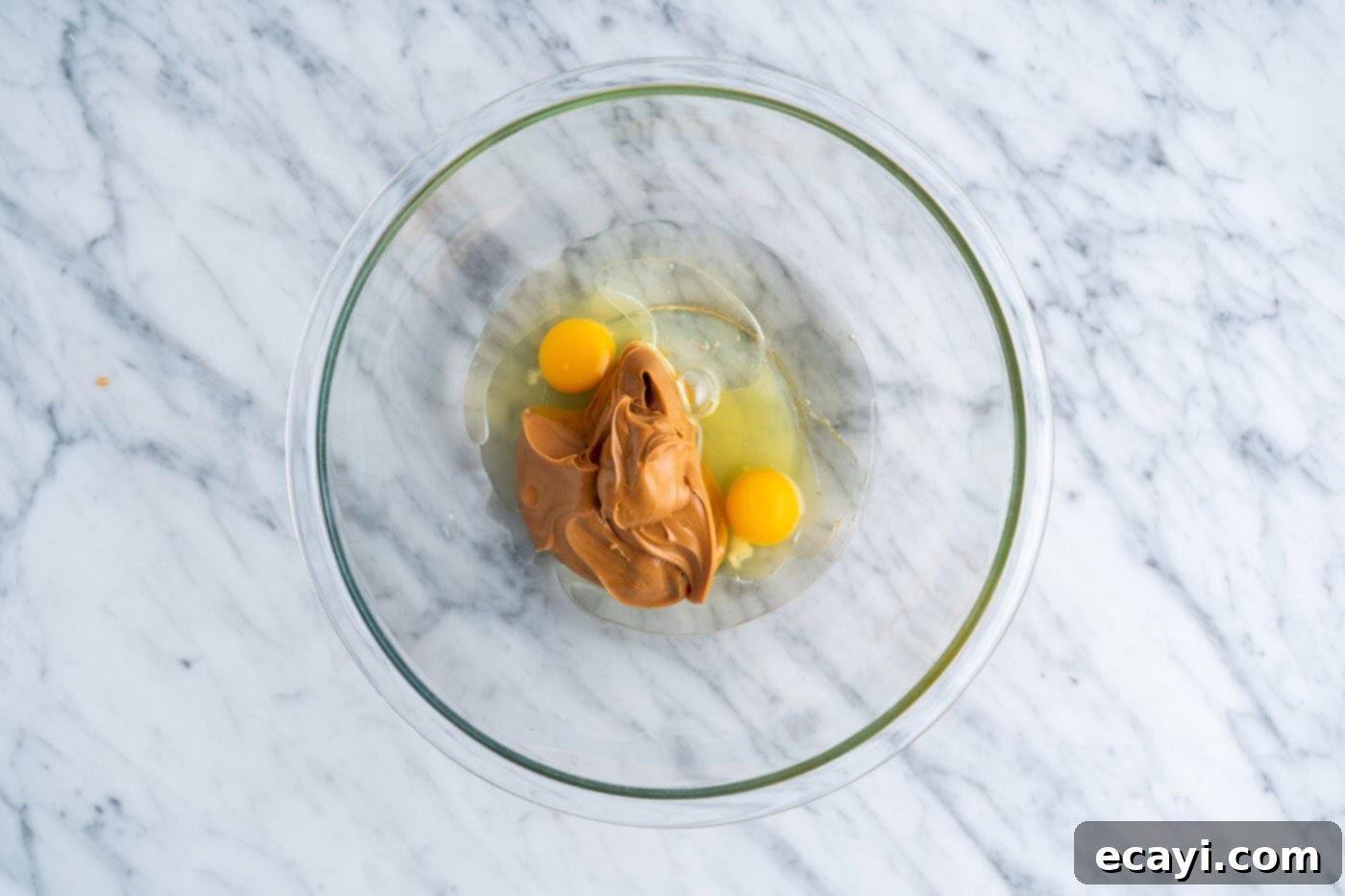 Peanut Butter Cake Mix Delights 5 Eggs, peanut butter, and oil in a bowl before mixing.