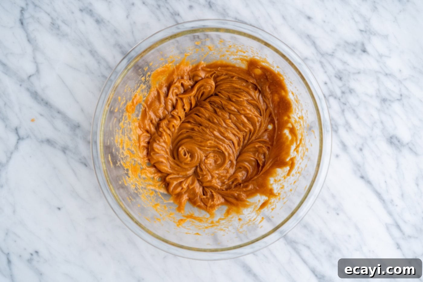 Peanut Butter Cake Mix Delights 6 Eggs, oil, and peanut butter mixed together in a bowl, creating a smooth mixture.