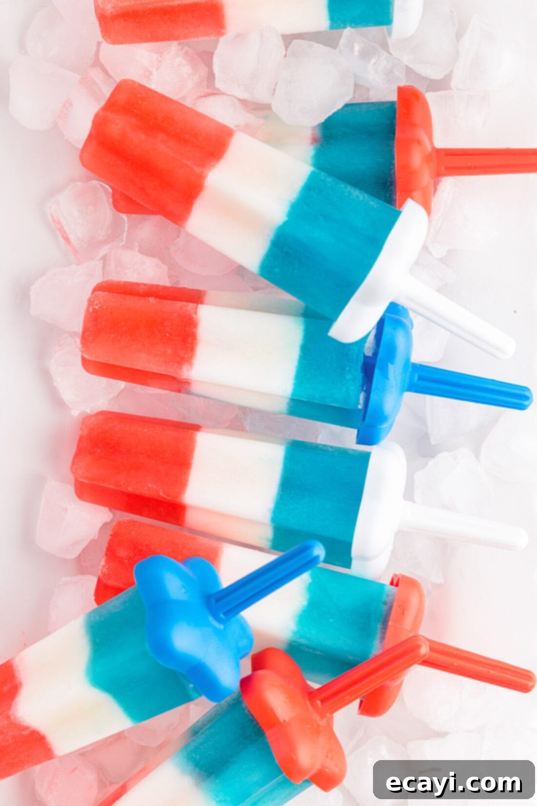 Stars & Stripes Freeze Pops 3 A tray filled with ice and several homemade patriotic bomb pops, ready to be served at a Fourth of July celebration.