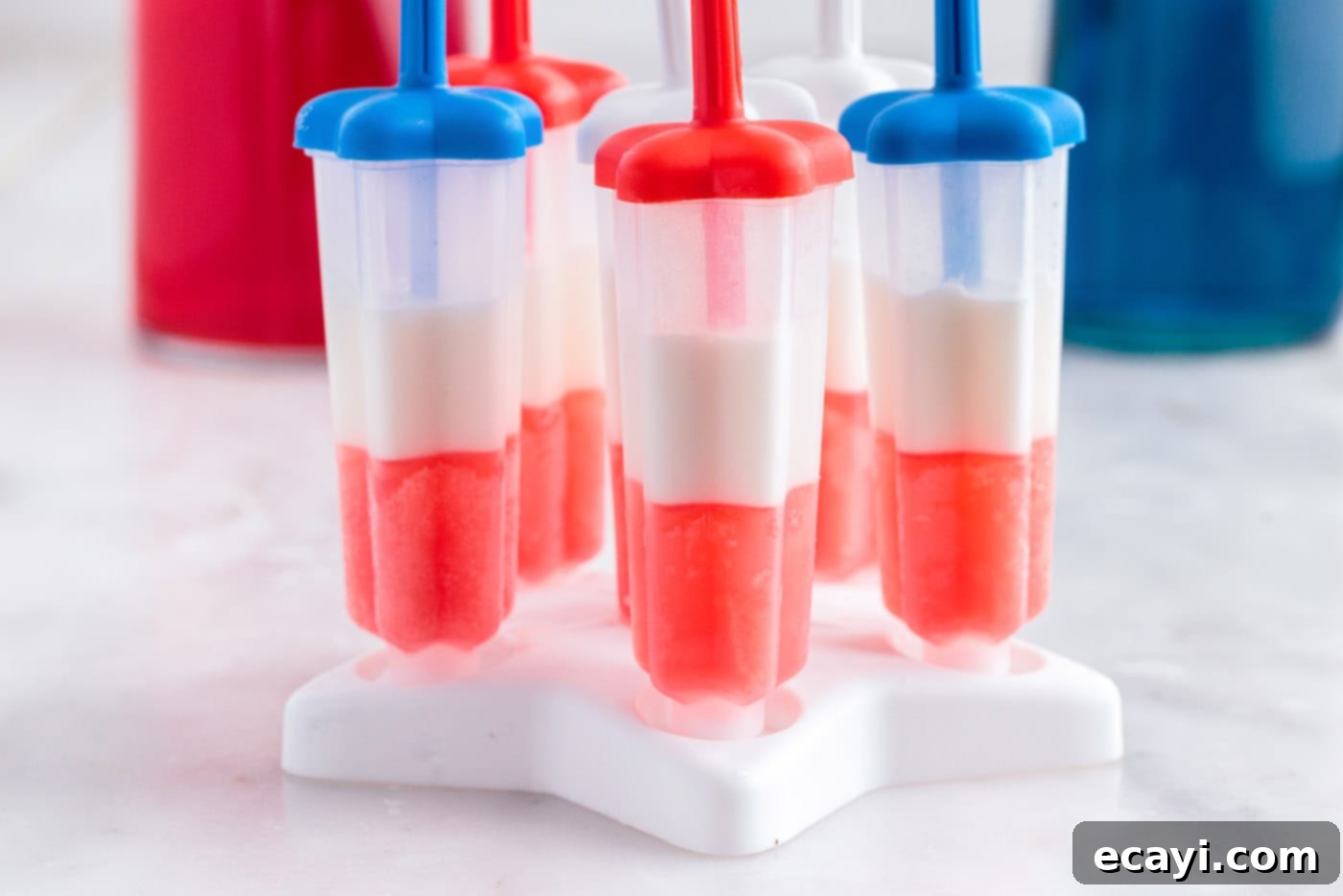 Stars & Stripes Freeze Pops 7 Popsicle molds with distinct red and white layers, showing the freezing progress.