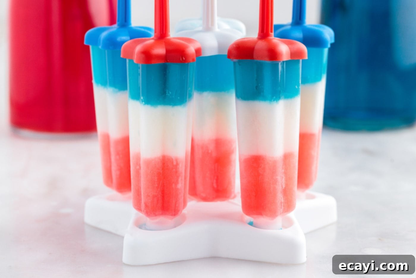 Stars & Stripes Freeze Pops 8 All three layers—red, white, and blue—are now in the popsicle molds, ready for final freezing.