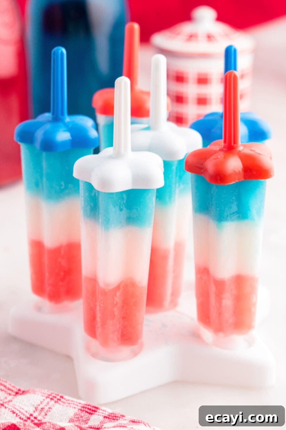Stars & Stripes Freeze Pops 9 Close-up of patriotic bomb pops still in their molds, showcasing the vibrant red, white, and blue layers.