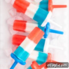 Stars & Stripes Freeze Pops 10 Patriotic Bomb Pops resting over ice, showcasing their vibrant colors