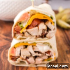 Signature Chicken Bacon Ranch Wrap 16 Close up photo of a Chicken Bacon Ranch Wrap cut in half and stacked on top of eachother